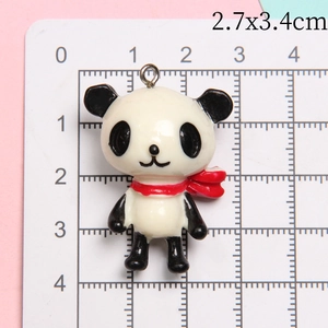 Detailed macro view showing the panda resin pendant dimensions of 2.7x3.4cm on a scale