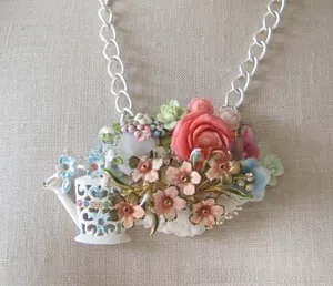 Detailed macro view of pastoral flower teapot pendant with pink roses and crystals