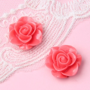 Makroaufnahme von zwei 18mm rosa Harz-Rosen-Cabochons für DIY-Schmuck und Haarschmuck