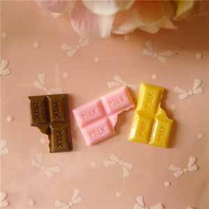 Detail of DIY chocolate resin charms with MILK engraving for phone cases and hair clips