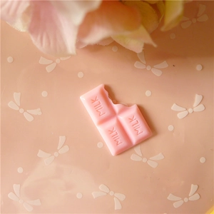 Detailed macro view of a pink chocolate resin charm with MILK text for DIY crafts