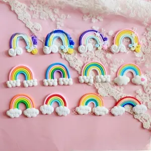Detailed view of colorful clay rainbow and cloud charms for DIY phone case decoration