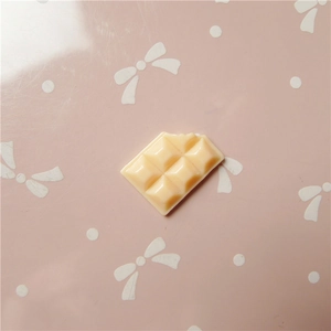 Macro detail of cream chocolate resin charm with realistic bite mark for DIY crafts