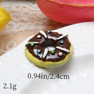 Macro view of 2.4cm resin chocolate donut charm with white stripes and colorful sprinkles