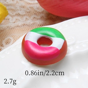 Macro shot of 2.2cm miniature resin donut showing colorful frosting and texture details