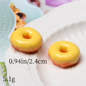 Macro detail of 2.4cm resin donut charms showing realistic glaze texture and size metrics