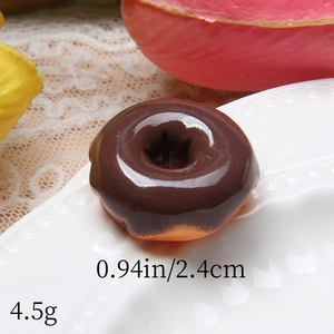 Macro detail of artificial chocolate donut resin model with size and weight annotations