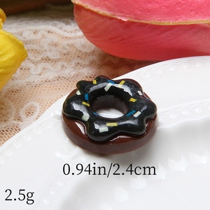 Macro detail of chocolate donut resin pendant with colorful sprinkles for DIY crafts