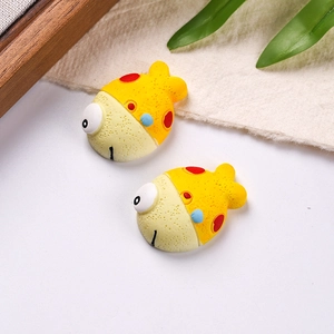 Detailed view of two cute resin clownfish charms for DIY crafts and shoe decoration