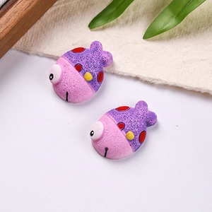 Detail of colorful resin clownfish charms with textured matte finish for DIY accessories