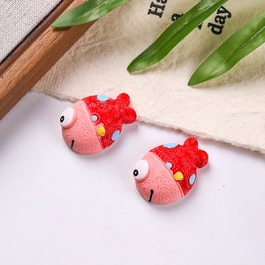 Detailed macro view of two colorful resin clownfish charms for DIY crafts and accessories
