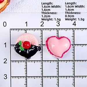 Resin heart and dessert charms shown on a scale for precise size measurements