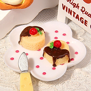 Miniature resin heart cakes with chocolate syrup on flower plate for DIY crafts