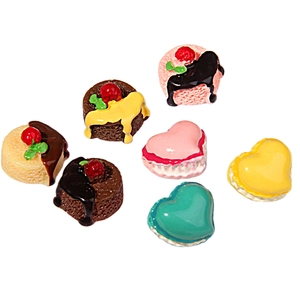 Macro detail of resin miniature heart cakes and dessert charms for DIY crafts and decor