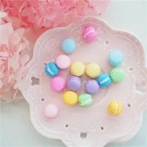 Close-up of colorful polymer clay mini macaron charms for DIY phone cases and jewelry
