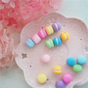 Macro shot of colorful resin macaron charms on a decorative white porcelain plate