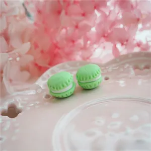 Macro detail of miniature green polymer clay macaron charm for DIY phone case crafts