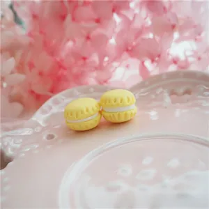Macro view of yellow macaron resin charms for DIY phone case and accessory crafts