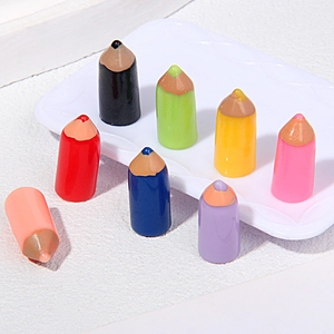 Close-up of eight colorful mini resin pencils for DIY craft and accessory decoration