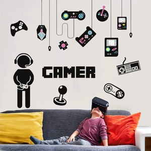Gamer wall decal featuring game controllers and player silhouette in a cozy bedroom setting
