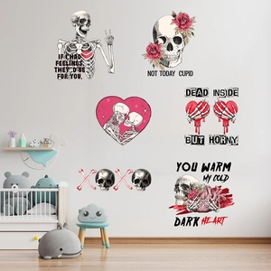 Detail showing gothic skull wall stickers with roses and hearts on a white wall