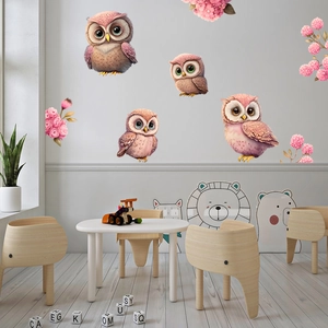 Détail de stickers muraux hibou à fleurs roses dans un décor de chambre d'enfant douillet