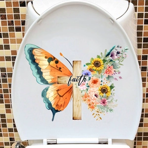 Detail of floral butterfly toilet lid sticker with a faith cross on mosaic wall