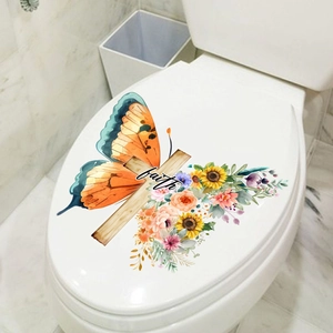Macro detail of butterfly and floral cross sticker with faith text on toilet lid