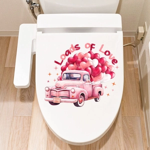 Close-up of Loads of Love truck sticker with heart balloons on a white toilet lid