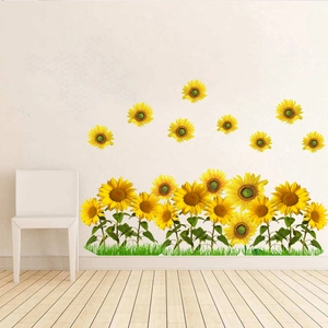 Detailed view of sunflower wall stickers with green leaves and grass on a white wall