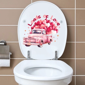 Loads of Love pink truck heart sticker applied on a white toilet lid in bathroom
