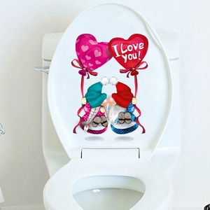 Close-up of Valentine's gnomes with hearts and I Love You text on a toilet lid sticker