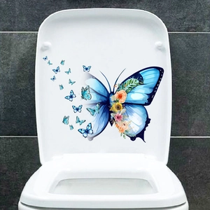 Detail of waterproof blue butterfly and flower sticker applied on a white toilet lid