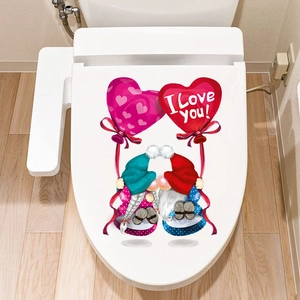Detail of Valentine gnomes kissing with heart balloons on a white toilet lid cover