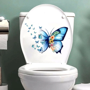 Detail of blue butterfly and floral wall sticker on a white ceramic toilet cover