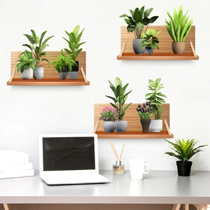 Three-piece set of wooden floating shelves with brown leather straps on white wall