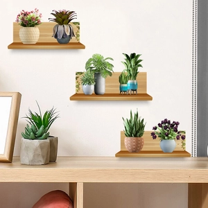 Three-piece light wood floating shelves with green potted plants on a white wall