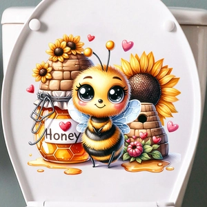 Close-up of cartoon bee and honey jar stickers on white toilet lid surface