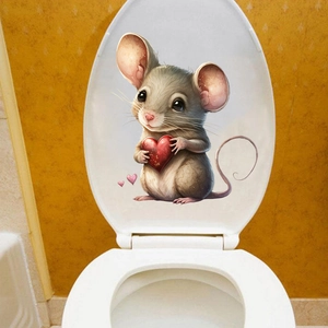 Detail of cartoon mouse sticker with red heart on a white toilet lid bathroom decor