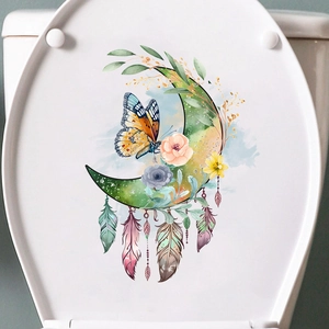 Detail of floral butterfly moon decal showing watercolor texture on white toilet cover