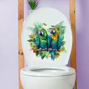 Detailed view of colorful watercolor parrots and tropical leaves on a white toilet lid