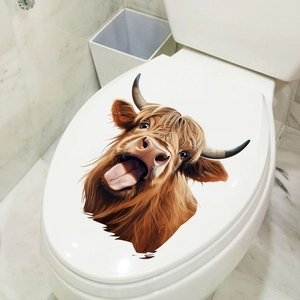 Detailed close-up of a funny Highland Cow decal on a white toilet lid for bathroom decor