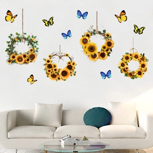 Close-up of sunflower wreath and blue butterfly wall stickers on a white living room wall