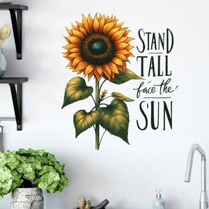 Detail of sunflower wall sticker with Stand Tall face the Sun text on a white kitchen wall