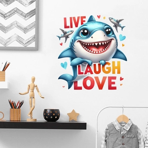 Detail of cute blue cartoon shark wall sticker with Live Laugh Love quote in kids room