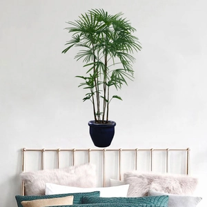 Detail of green leaf plant wall sticker showing palm-shaped leaves and blue pot decal
