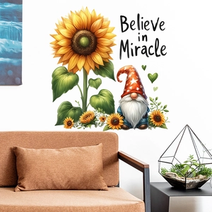 Detail of sunflower and gnome wall sticker with Believe in Miracle text on white wall