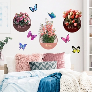 Detail of floral wall stickers with colorful butterflies and potted plants in bedroom