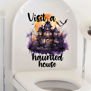 Close-up of Halloween toilet sticker with haunted house, pumpkin and moon design