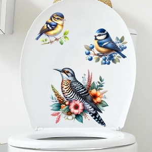 Detail of waterproof bird and flower stickers on a white toilet lid for bathroom decor